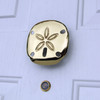 sand dollar door knocker brass on white door