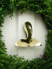 whale tail door knocker brass on white door