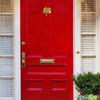 four leaf clover door knocker on red door
