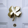 four leaf clover door knocker brass on white door