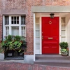 ring door knocker brass on red door brick house