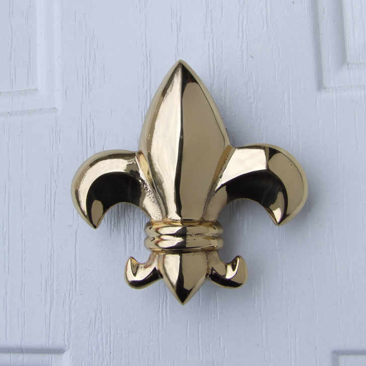 fleur de lys door knocker brass on white door