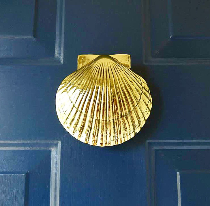 scallop door knocker brass on blue door