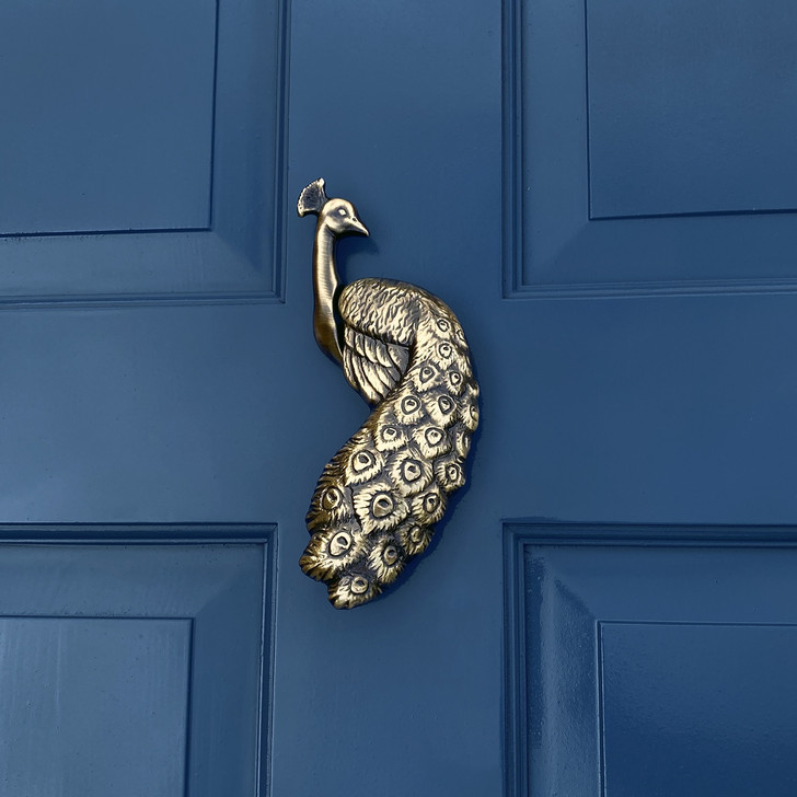 peacock door knocker antique brass on blue door