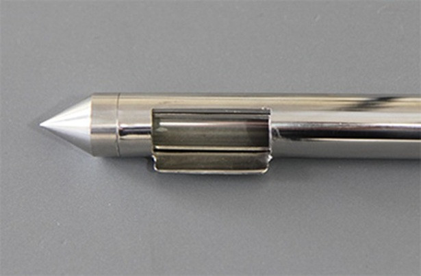 The sampler has a scraper next to the pocket. 
This is used to push the powder into the pocket.