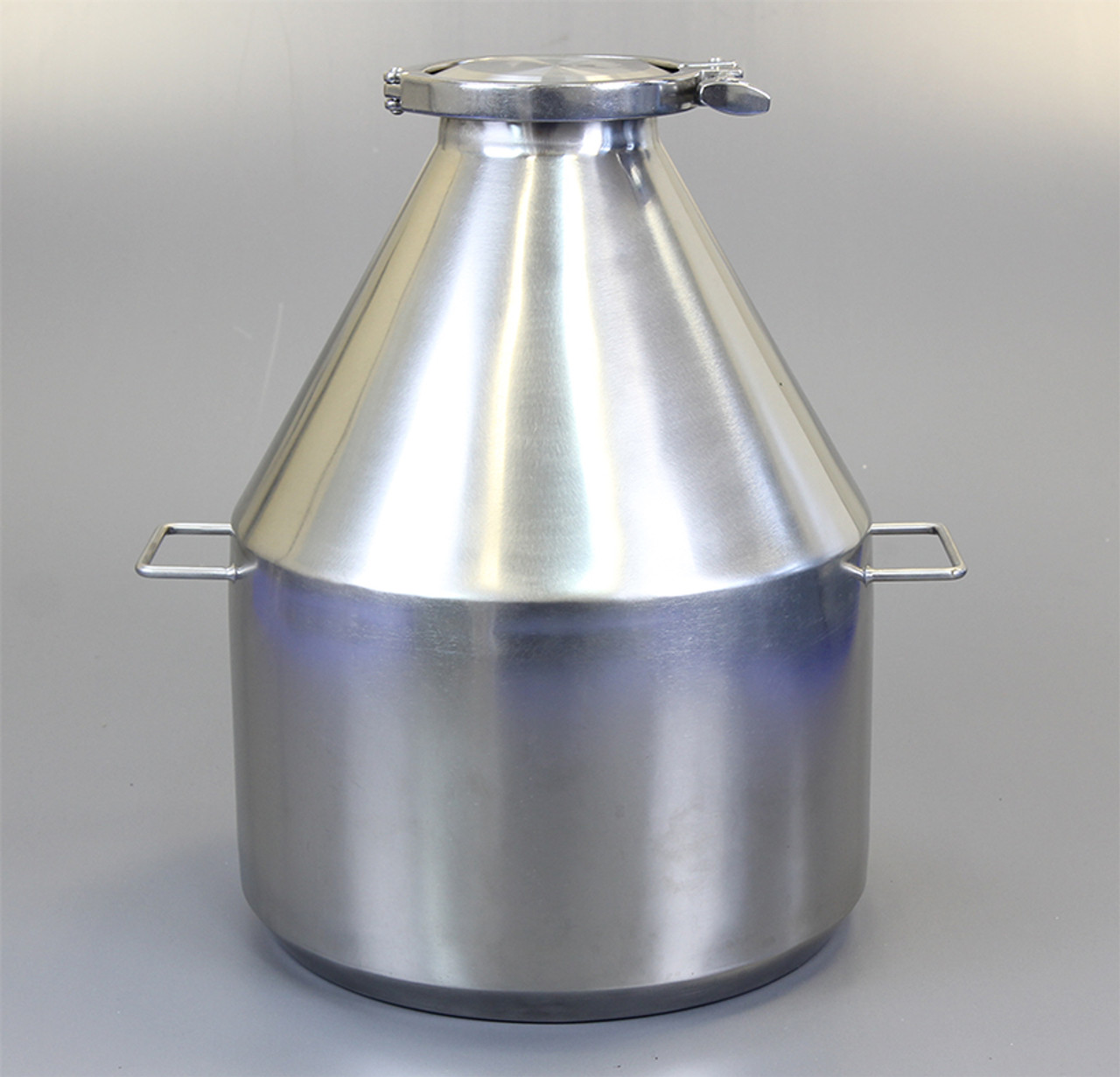 Nominal Volume: 20L
Material of Construction:
Body: 316 stainless steel
Side Handles: 304 stainless steel
Lid: 316 stainless steel
Clamp: 316 stainless steel (may be 304 stainless steel)
Gasket: Silicone (conforms to FDA CFR 177.2600)

Method of Construction: Crevice free body, welds ground & polished
Surface Finish: Better than 0.5 microns Ra
Overall Height: 408mm
Body Height: 395mm
Body Diameter: 307mm
Nominal Weight (body, lid, clamp & gasket): 5.5 Kg
Note: The neck of the container is fitted with a 4” diameter ferrule which conforms to BS4825-3