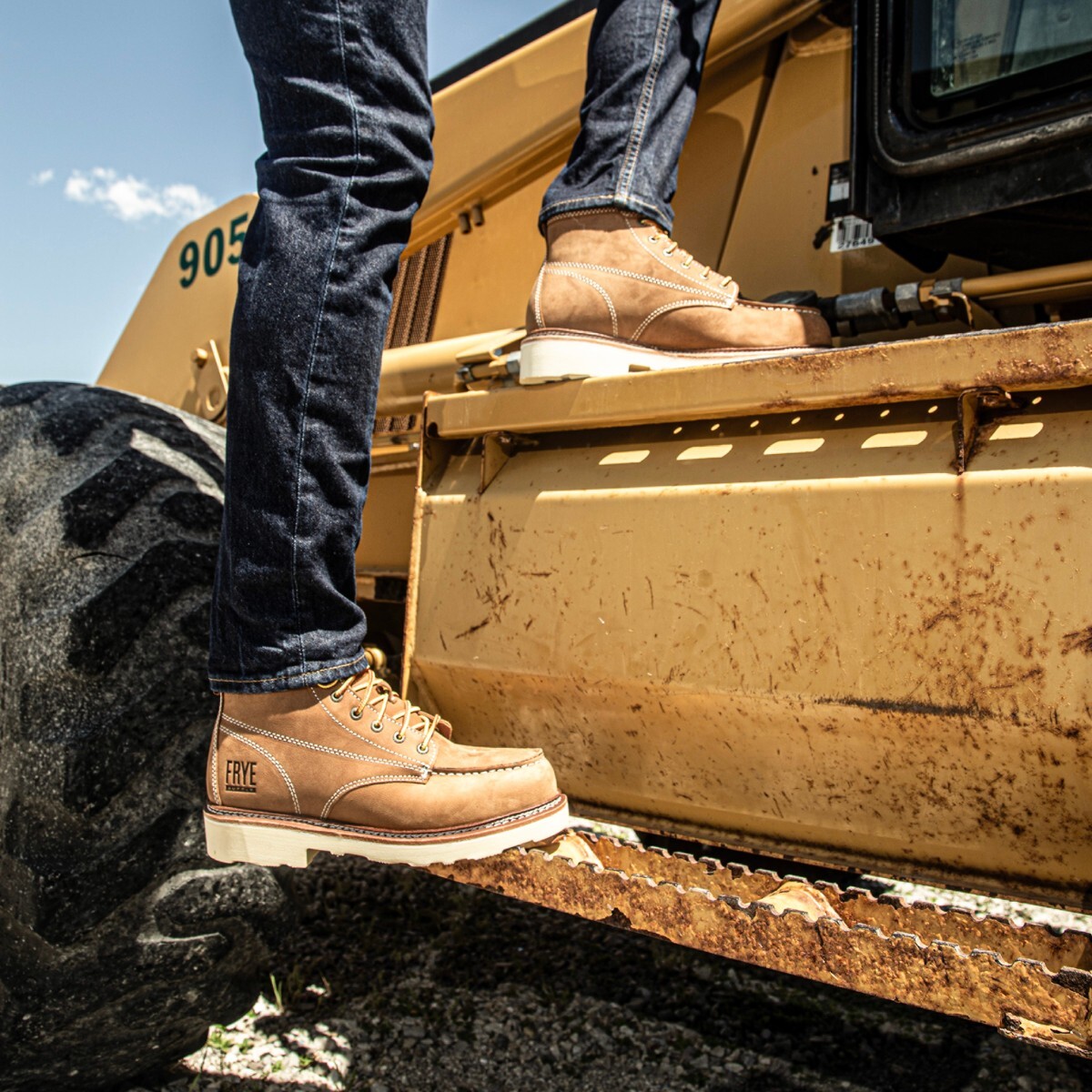 fr40302-img-6257-square.jpg Man stepping up into machinery in construction work boots.