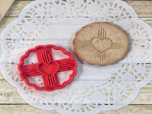 Cookie cutter shaped like a zia symbol, with a heart in the middle.