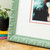 Corner image of print framed in ornate french style picture frame moulding