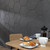 Breakfast room with dark grey hexagonal acoustic wall panels.