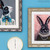 Close up of 2 rabbit paintings framed in Opera champagne silver ornate frames.