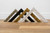 Vintage ornate picture moulding samples standing on wooden floor