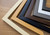 Selection of Polcore photo frame corner samples displayed on a desk.