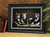Art print of 4 cats at a table framed in an ebony black frame with silver inner edge.