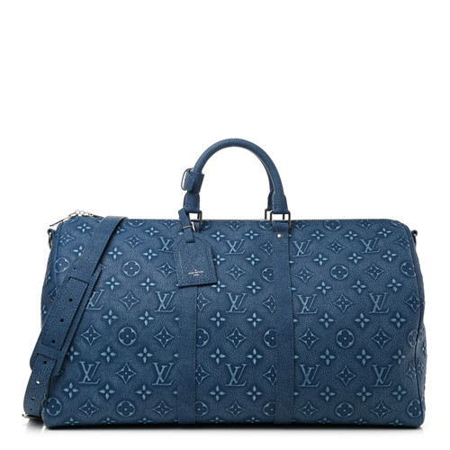 Louis Vuitton Keepall Bandoulière 50 in denim blue Monogram canvas with cowhide leather trim and adjustable strap