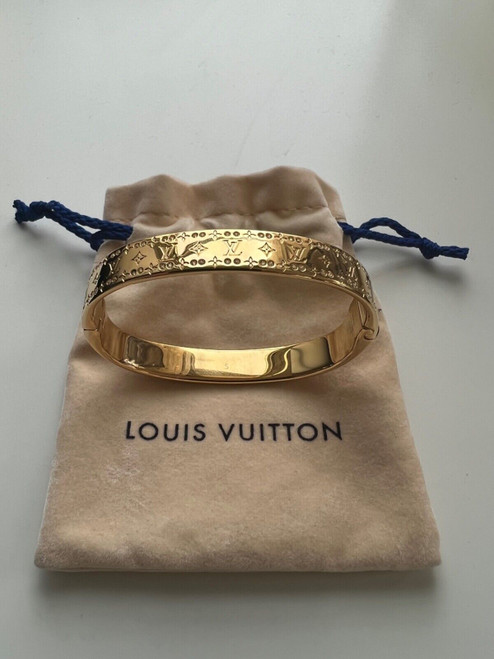 Louis Vuitton Empreinte 18K yellow gold bangle with trunk-nail imprint and LV Initials clasp, displayed in its original Louis Vuitton box