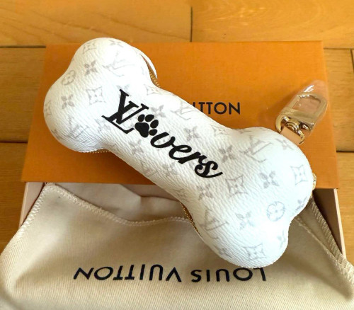 Louis Vuitton Bone Key Holder Bag Charm M02285 in white leather with embossed Monogram and gold-tone snap hook, new with tags.