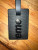 Close-up view of Louis Vuitton Supreme Epi Luggage Tags in Black and Red with white Supreme logo