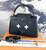 Authentic Louis Vuitton Capucines PM tote featuring layered leather and metal stud flower embellishments
