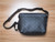 Adjustable leather shoulder strap and iridescent hardware on LV Fragment Apollo Messenger PM
