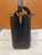 Front view of Louis Vuitton Capucines Mini M56669 in black Taurillon leather with gold Monogram Flower crown