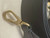 Side profile of Louis Vuitton Capucines Mini M56669 showing removable wide strap and leather top handle