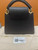 Rear view of Louis Vuitton Capucines Mini M56669 in black Taurillon leather highlighting smooth back panel