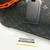 Louis Vuitton Keepall Bandoulière 50 in Absolute Black Monogram Taurillon leather with orange chain strap accents
