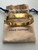 Louis Vuitton Empreinte 18K yellow gold bangle with trunk-nail imprint and LV Initials clasp, displayed in its original Louis Vuitton box