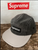 Side view black and green Supreme Suck Camp Cap structured 5‑panel