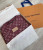 Close-up of Louis Vuitton Monogram and Trunk design on Bordeaux shawl