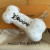 Louis Vuitton Bone Key Holder Bag Charm M02285 in white leather with embossed Monogram and gold-tone snap hook, new with tags.