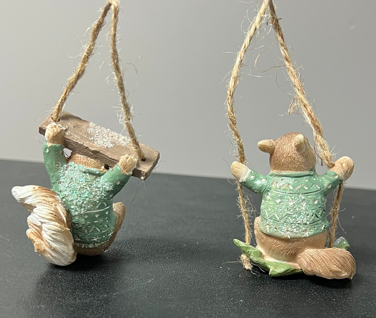 Cute squirrel on swing or holding swing ornament.