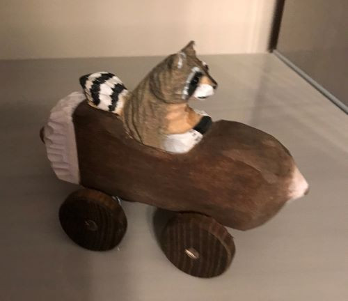 Raccoon in Log Car