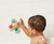 Itzy Ritzy Pop & Whirl  Fidget Spinner Travel & Bath Toy for Babies & Toddlers  Fidget w/Textured Silicone Poppers to Develop Fine Motor Skills  Sticks to Highchairs, Tables, Tubs More (Smile)