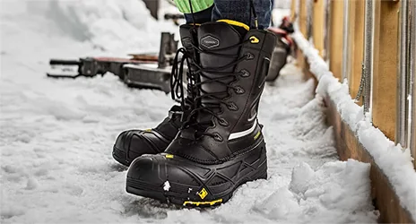 Terra Crossbow insulated pac boots in the snow on a job site