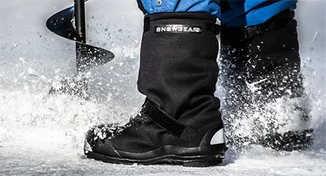 A Snowgear studded overshoe on the ice while drilling an ice hole
