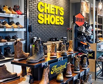 Inside a Chet’s Shoes store today, with work boots on display under the Chet’s Shoes sign