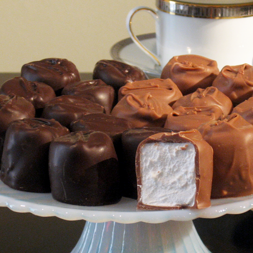 Milk chocolate and dark chocolate covered marshmallows cut in half to show center