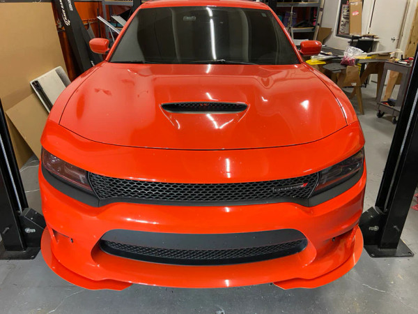 Close-up of Downforce Solutions powder-coated aluminum front half splitters installed on a 2020 Dodge Charger SRT, showcasing aggressive styling and precise fitment.