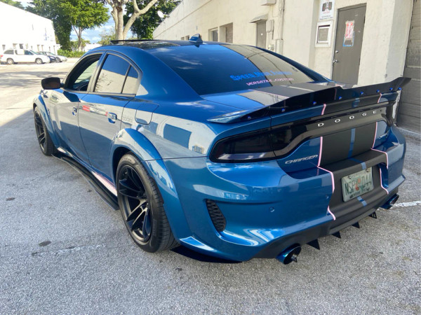 Side view of a Dodge Charger Widebody with Downforce Solutions T6061 aluminum side splitters, showcasing aggressive street styling and custom fit.