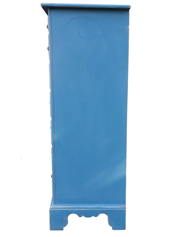 Tall blue dresser shown from the side.