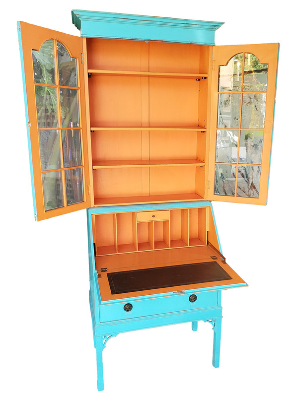 Turquoise and orange secretary with desk and cupboards opened.