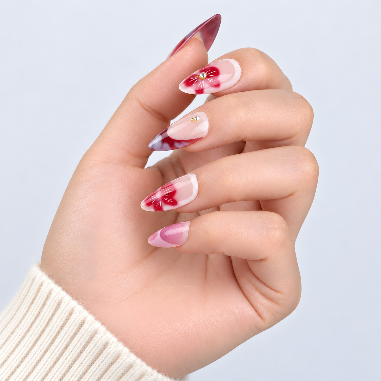 Side view of the burgundy tips and floral almond nail designs