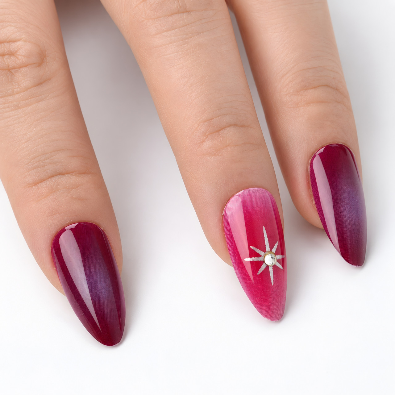 Close-up of the starburst accent and glossy almond nail surface