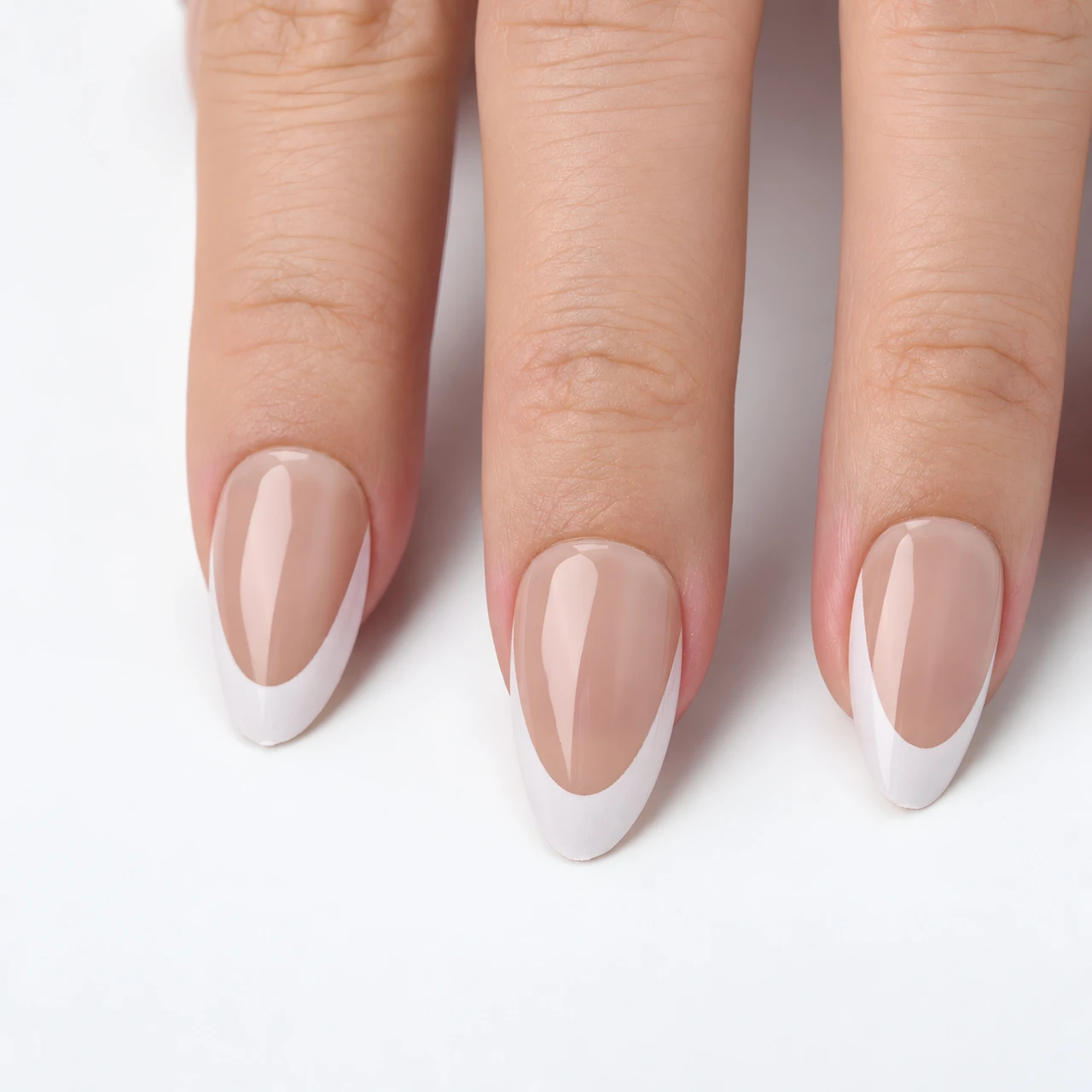 Close-up details of nude bases and white French borders on short almond nails