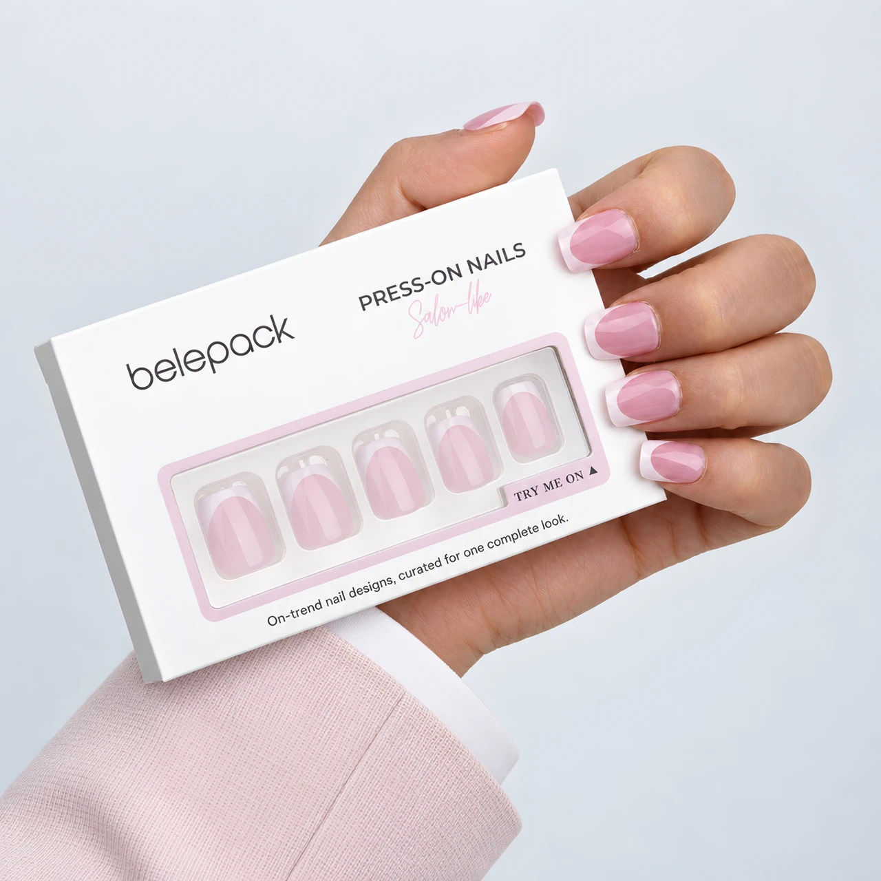Pink French tip nails and Belepack box in a hand-held view