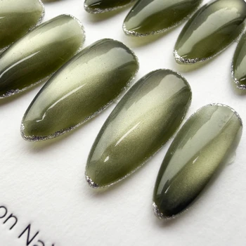 Close-up of olive green shimmer and fine silver-colored edging on press-on nails.