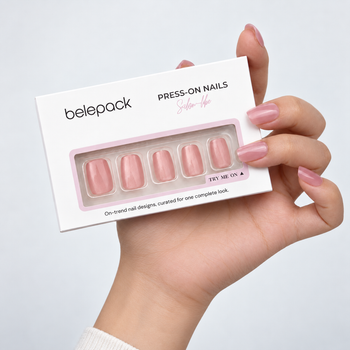 BP008 Nude Pink Shimmer Short Square Press-On Nails — hand-held Belepack package styling scene