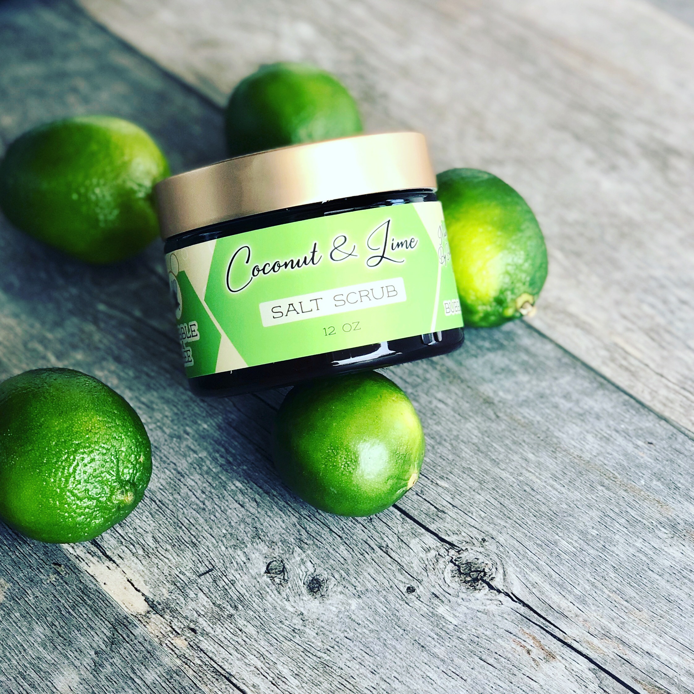 photo of coconut lime salt scrub with limes on a wooden background